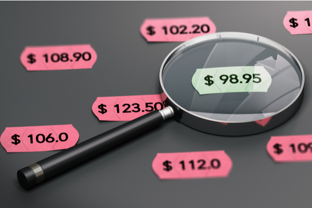 Magnifying glass on sticky labels with numbers written on them