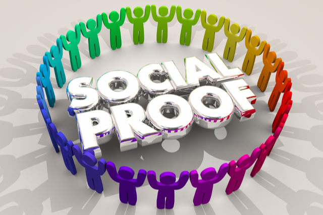 Human vector images holding hands to make a circle around the words “social proof”