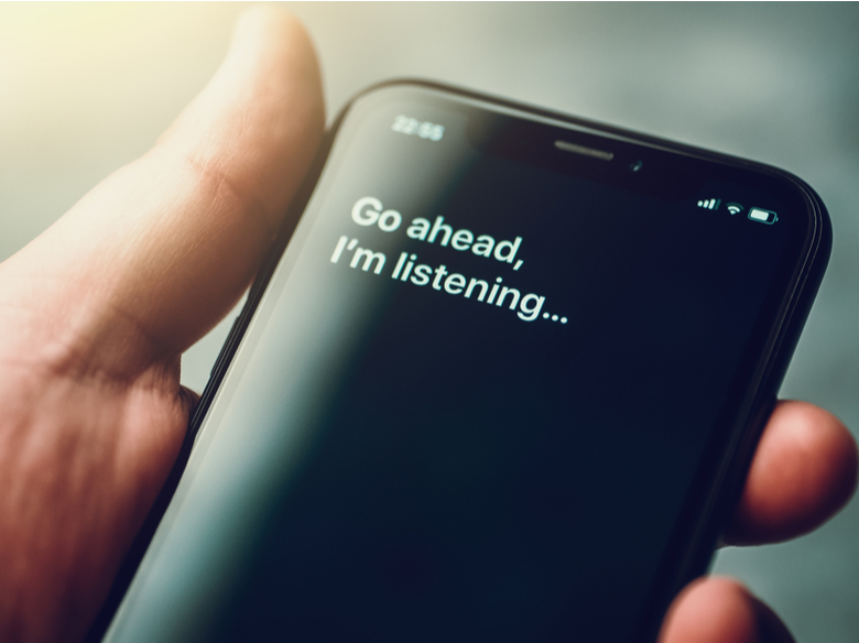 Man holding a phone with a text that says "Go ahead. I'm listening..."