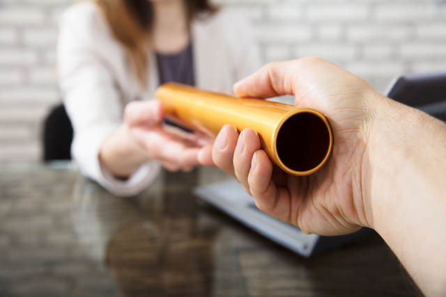 Man handing off the baton to employee